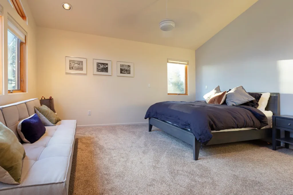 bedroom with queen bed and futon