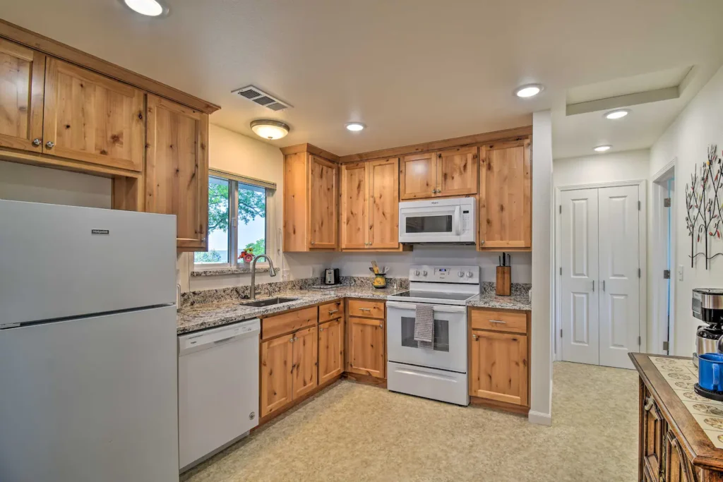 kitchen with wood cabinets and white appliances