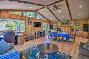 living room with couches and television, tall beamed ceilings