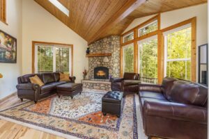 living room with stone fireplace and leather couches