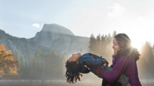 Mother holding laughing child with Half Dome in the background