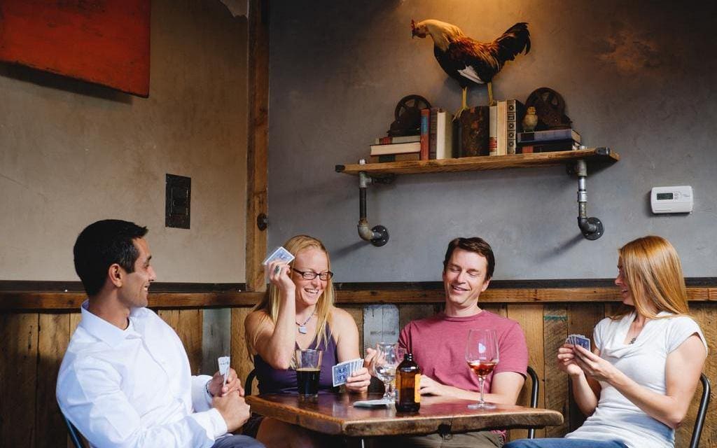 Couples playing cards at The Alley in Mariposa