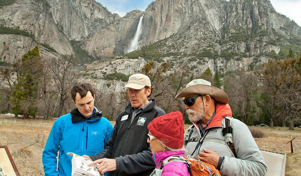 Group of people surrounding a Yosemite Conservancy Outdoor Adventures tour leader