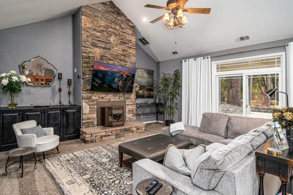 living room with fireplace, television, and seating