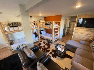 living and sleeping area with bunk beds and couches
