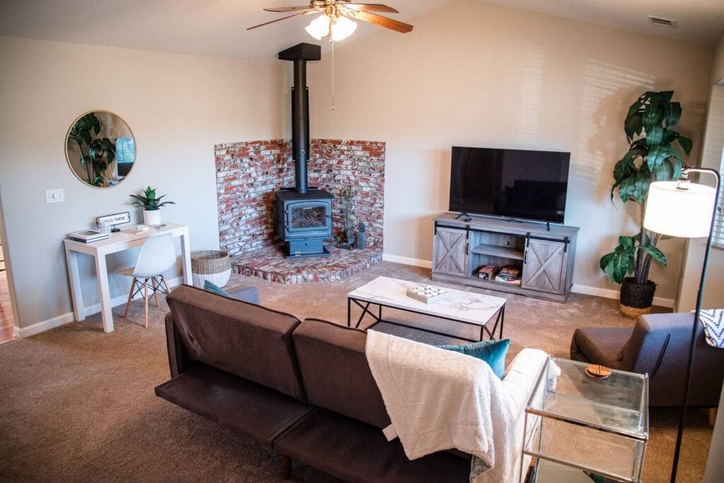 living room with wood stove, couch and television