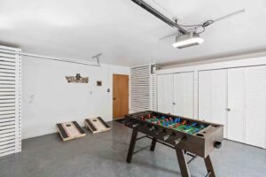 garage game room with foosball and corn hole