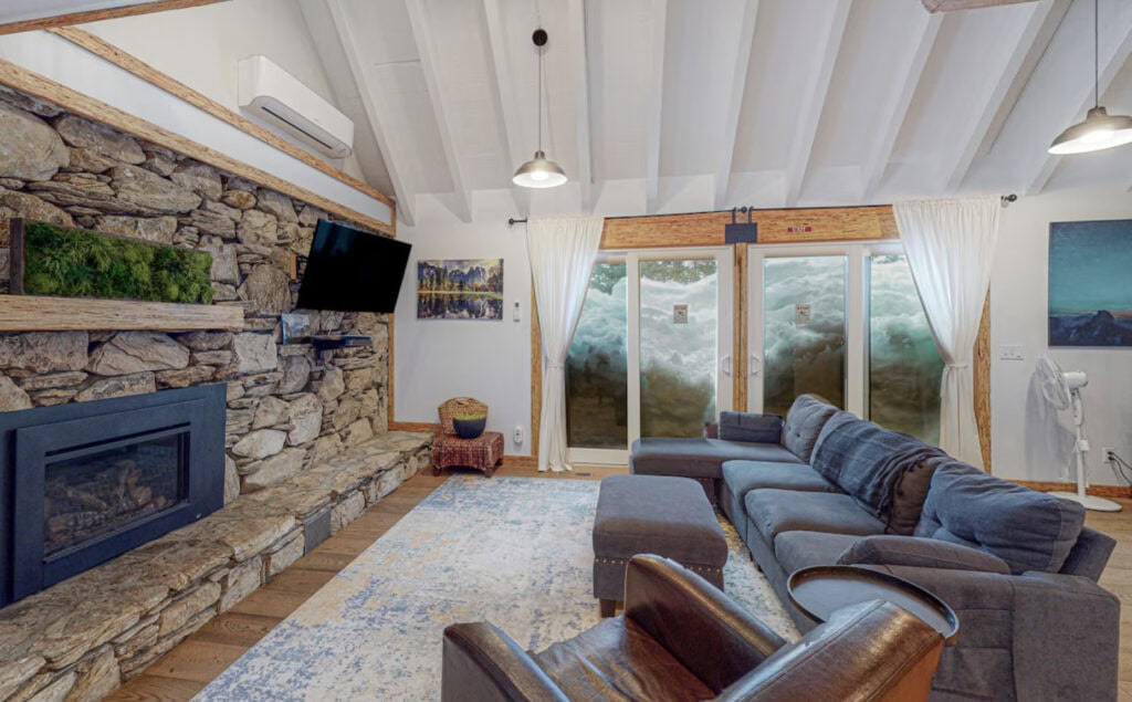 living room, fireplace, couch seating with television and patio doors