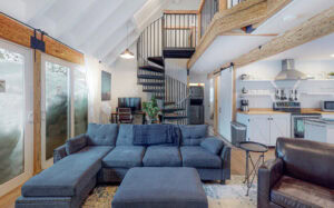 living room couch, desk with computer, spiral staircase