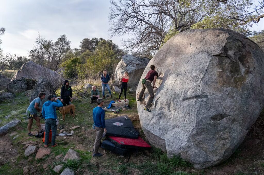 people climbing on boulders